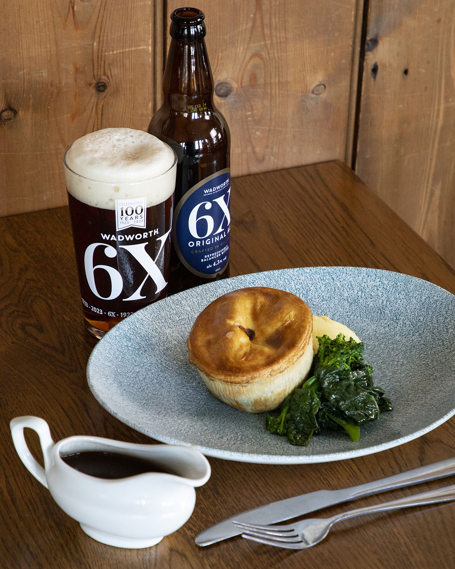 Pie and vegetables with a pint of 6X